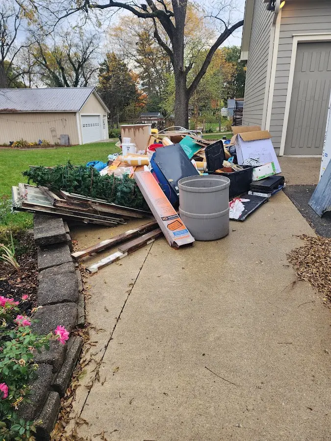 Dumpster being loaded with debris for Roofing Dumpster Rental in Greene